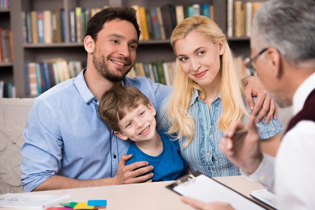 A family sitting at the table with a man and woman.